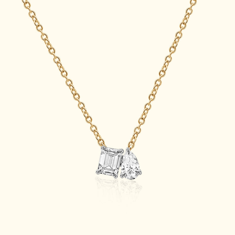 Gold chain necklace featuring two sparkling diamond charms.
