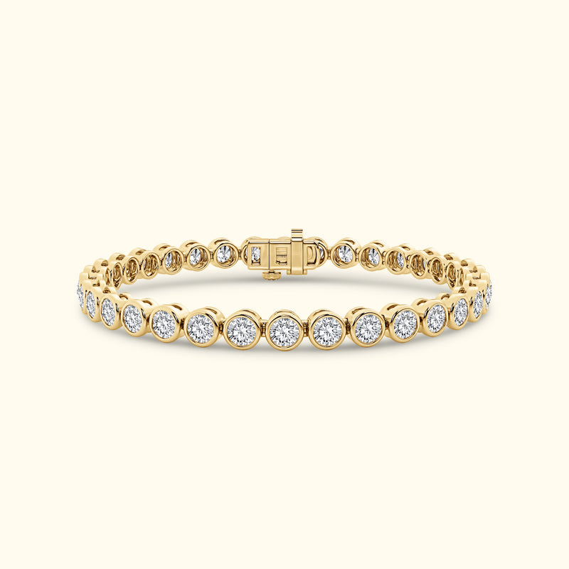 Gold tennis bracelet featuring round diamonds set in a sleek prong setting.