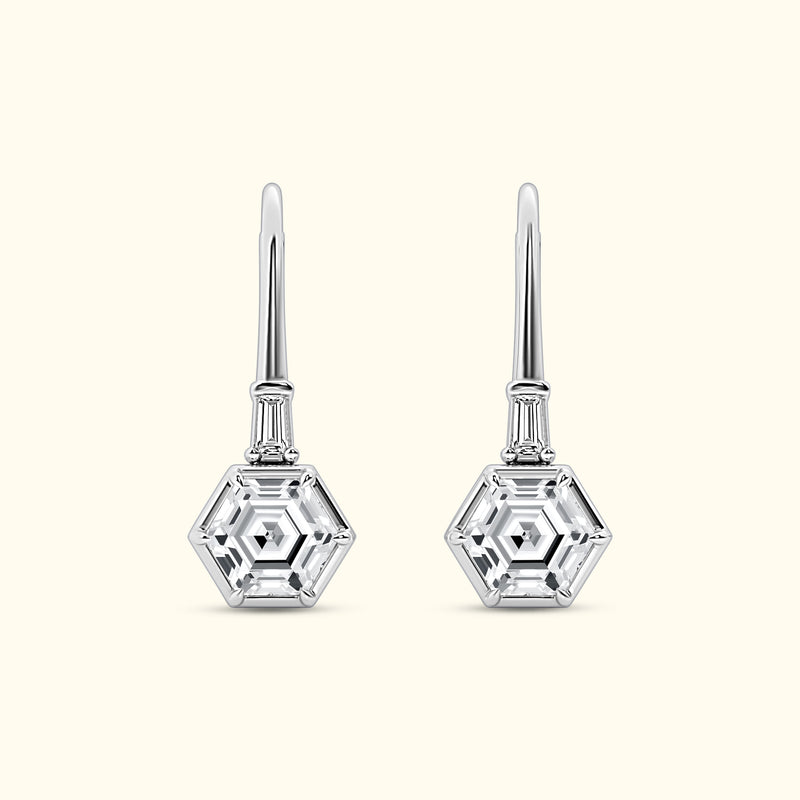 Silver hexagonal drop earrings with clear gemstones.