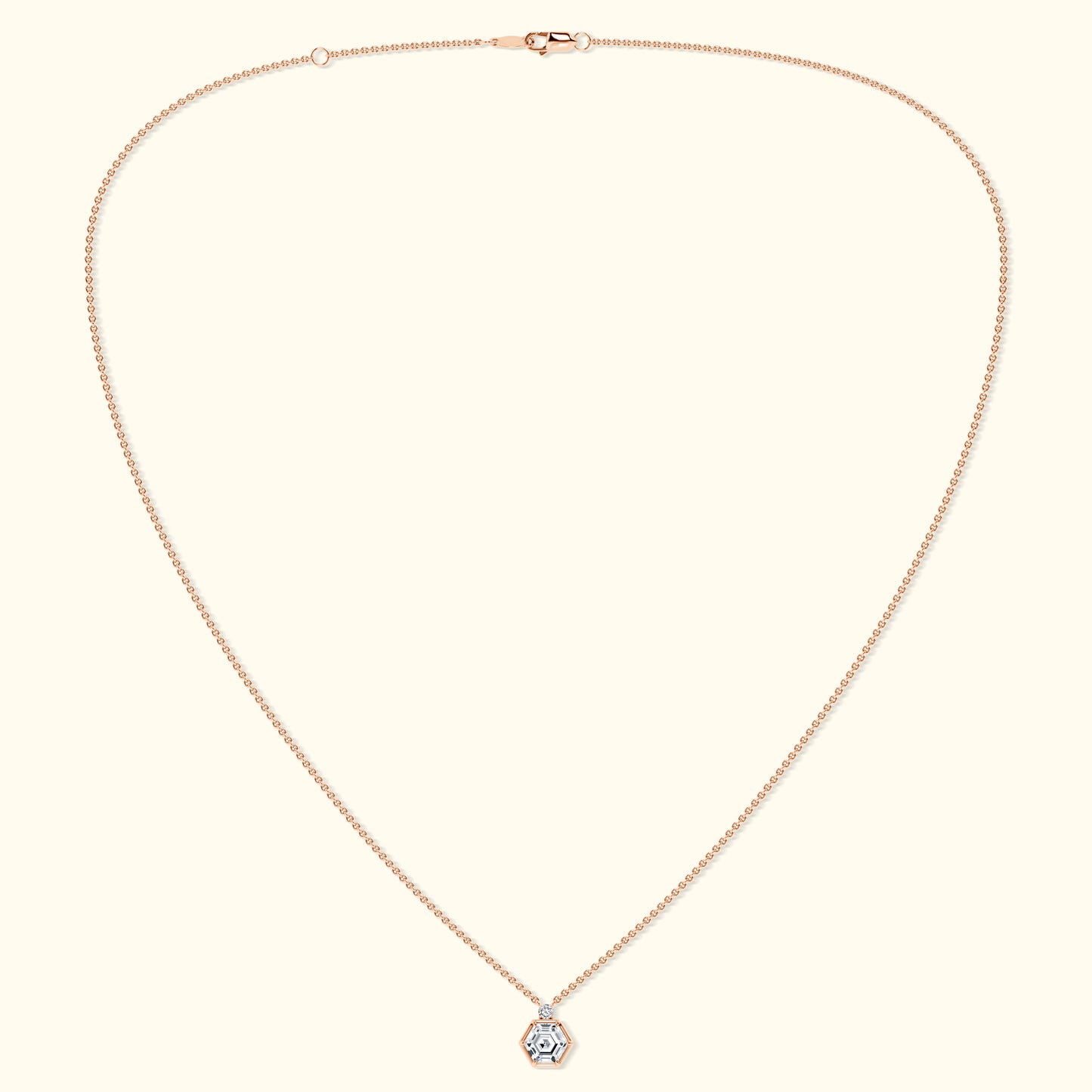 Delicate rose gold necklace featuring a hexagon pendant with a central gemstone.