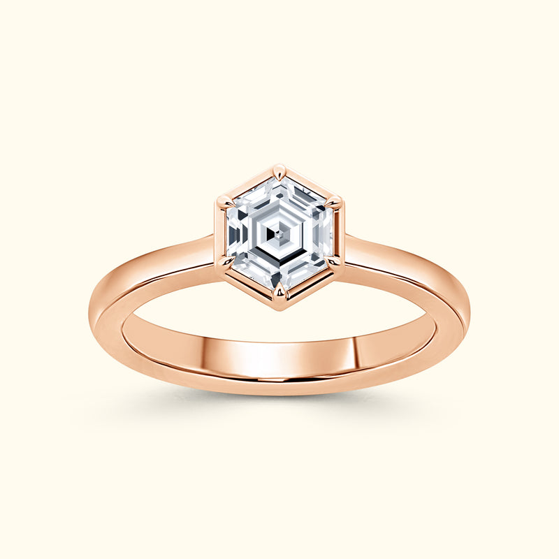 Rose gold ring featuring a hexagonal diamond centerpiece.