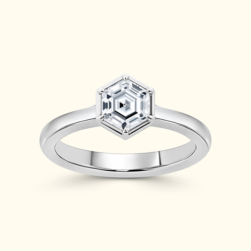 Elegant silver ring featuring a hexagonal diamond centerpiece.
