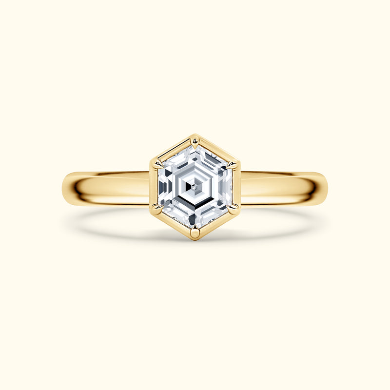 Gold ring featuring a hexagonal diamond setting with a polished band.