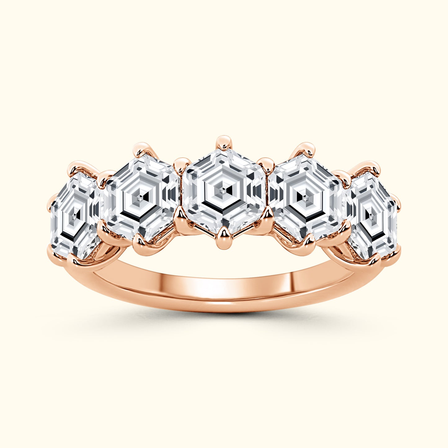 Rose gold ring featuring five hexagonal-cut diamonds set in a vintage design.