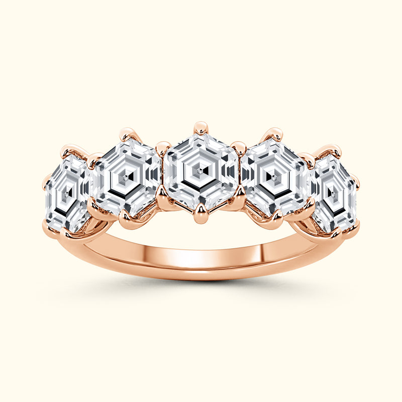 Rose gold ring featuring five hexagonal-cut diamonds set in a vintage design.