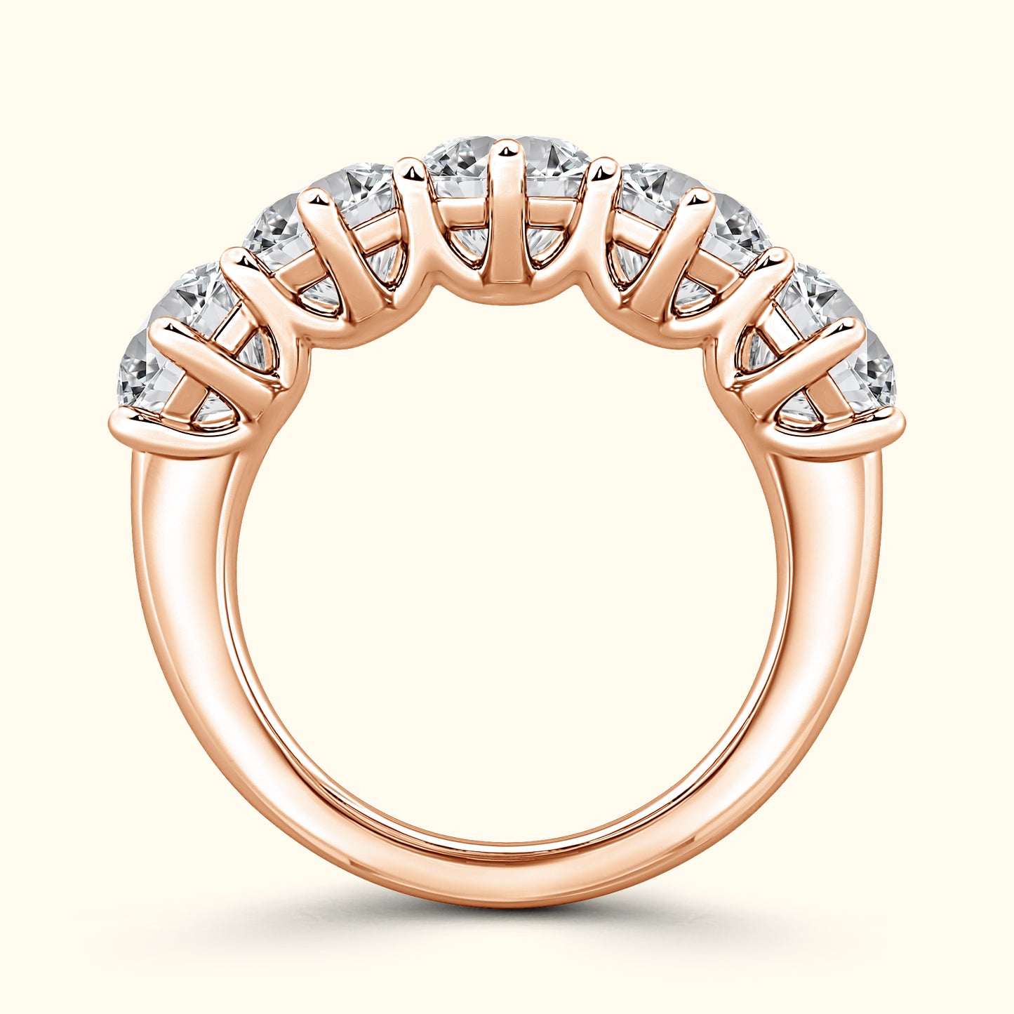 Rose gold ring featuring five sparkling stones set in a curved design.