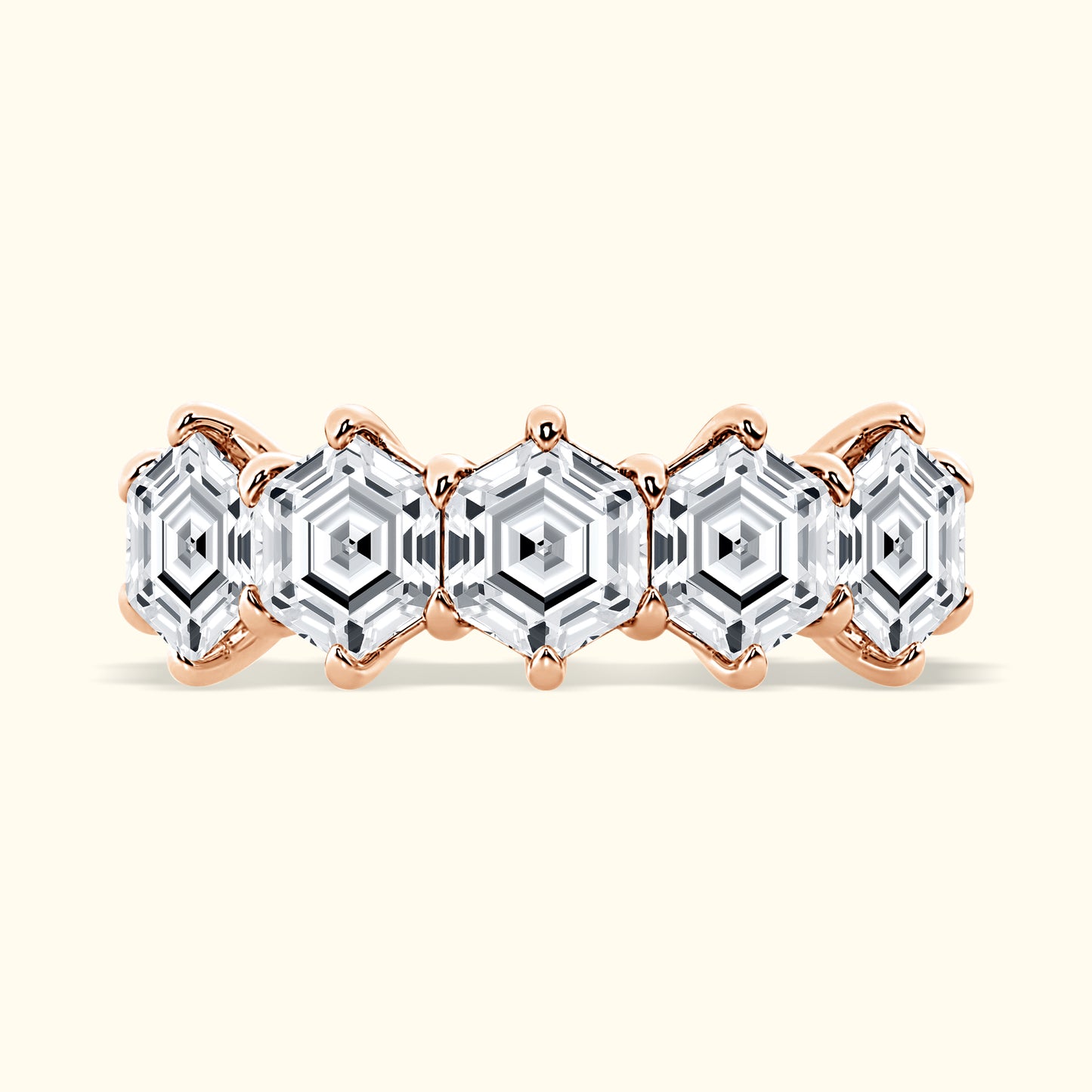 Rose gold ring featuring five hexagonal clear gemstones in a patterned design.