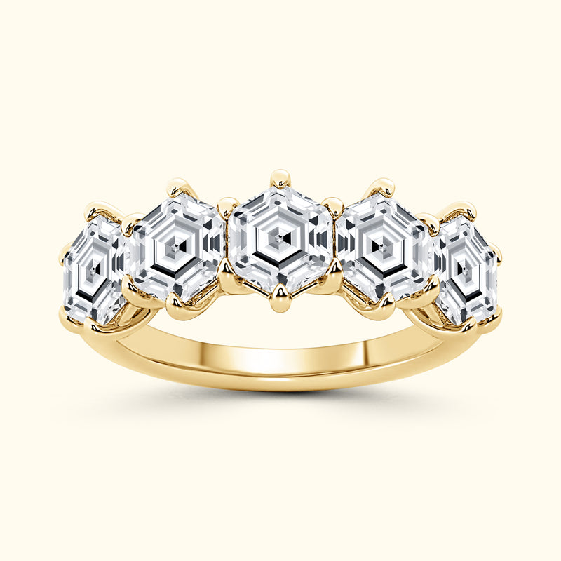 Gold ring featuring five hexagon-shaped clear stones set in a pronged design.