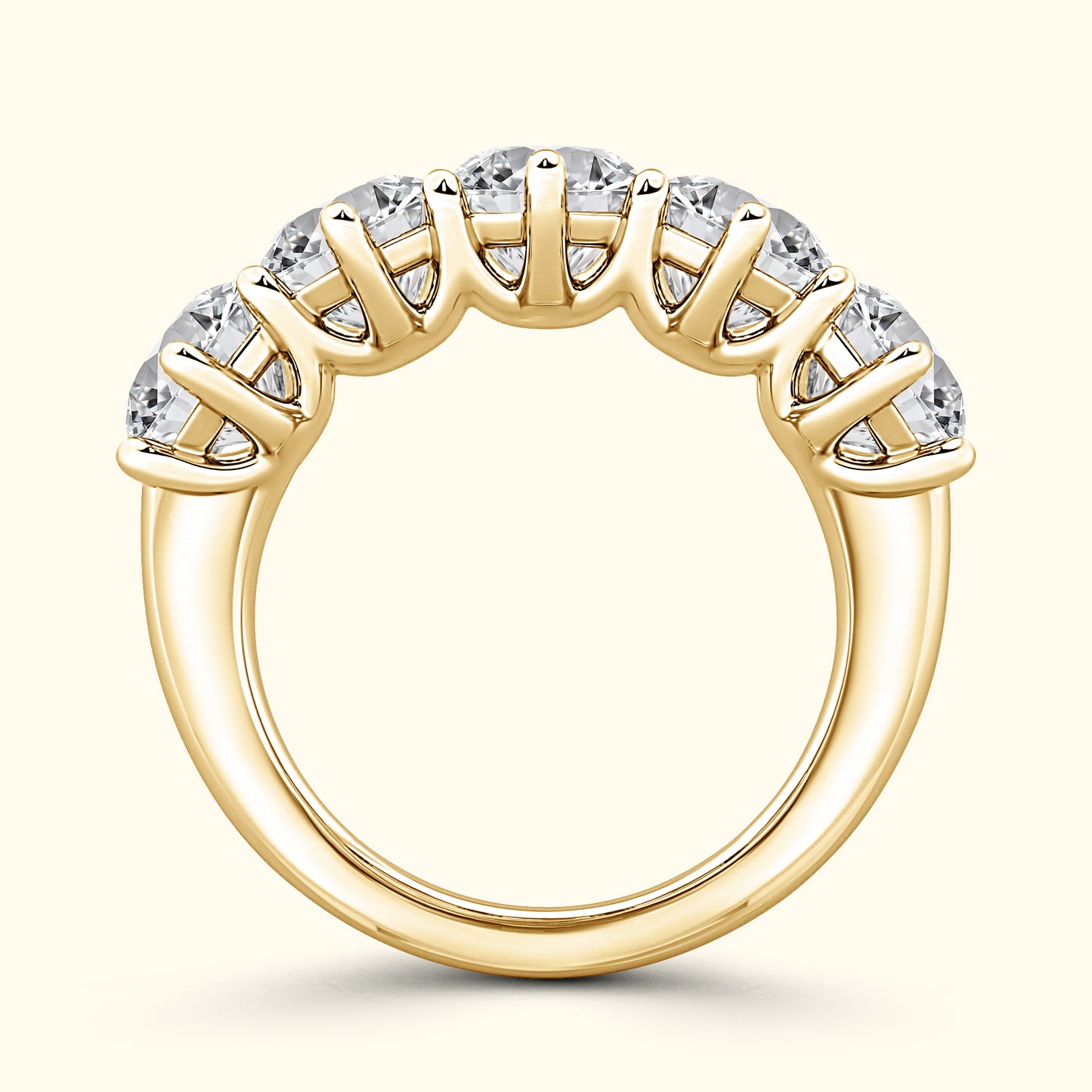 Gold band ring featuring five sparkling gemstones arranged in a row.
