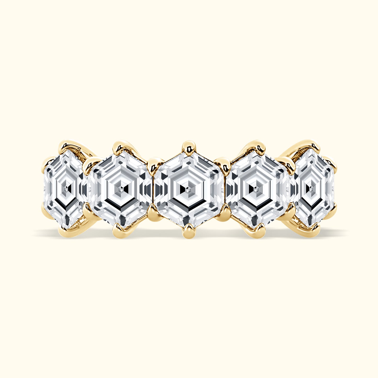 Gold band ring featuring five hexagonal clear gemstones.