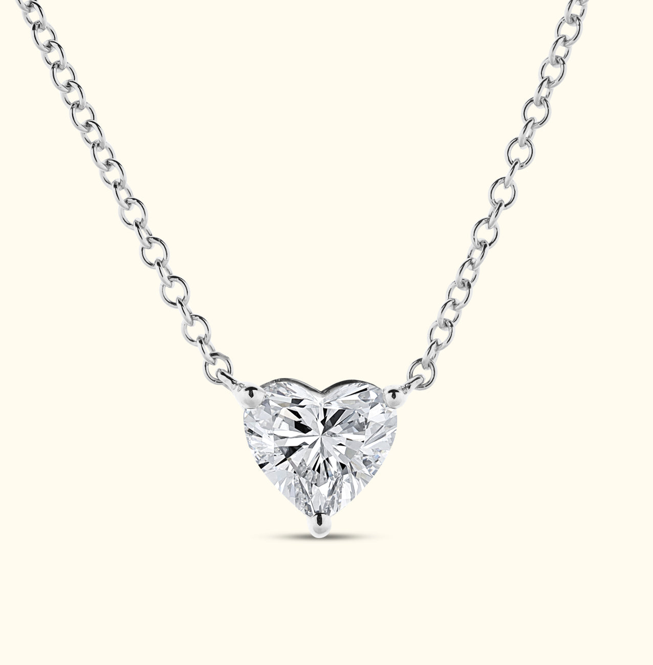 Heart-shaped diamond pendant on a delicate silver chain.