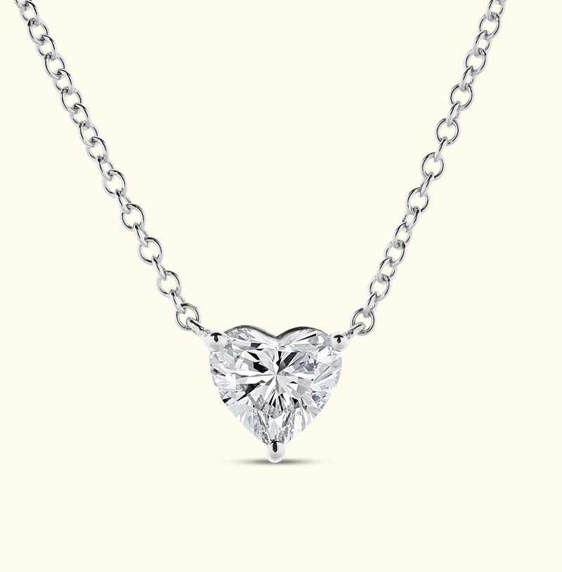 Heart-shaped diamond pendant on a delicate silver chain.