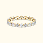 Gold band ring adorned with sparkling round diamonds.