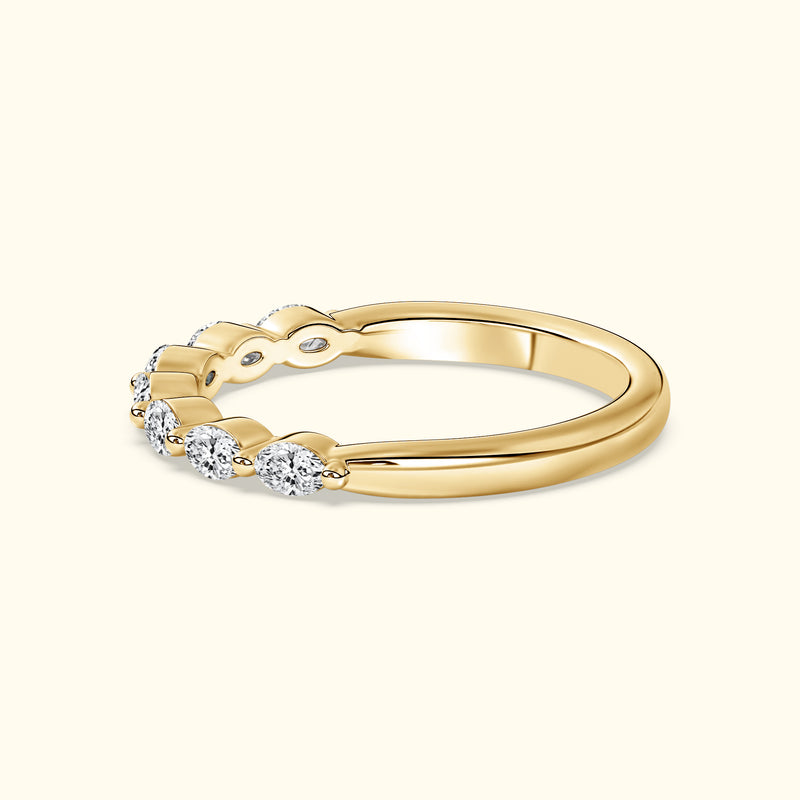 Gold ring with a twisted design featuring three sparkling diamonds.