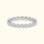 Elegant silver ring adorned with sparkling diamonds around the band.