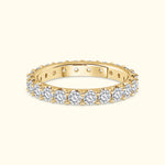Gold band ring adorned with shimmering round diamonds around the entire circle.