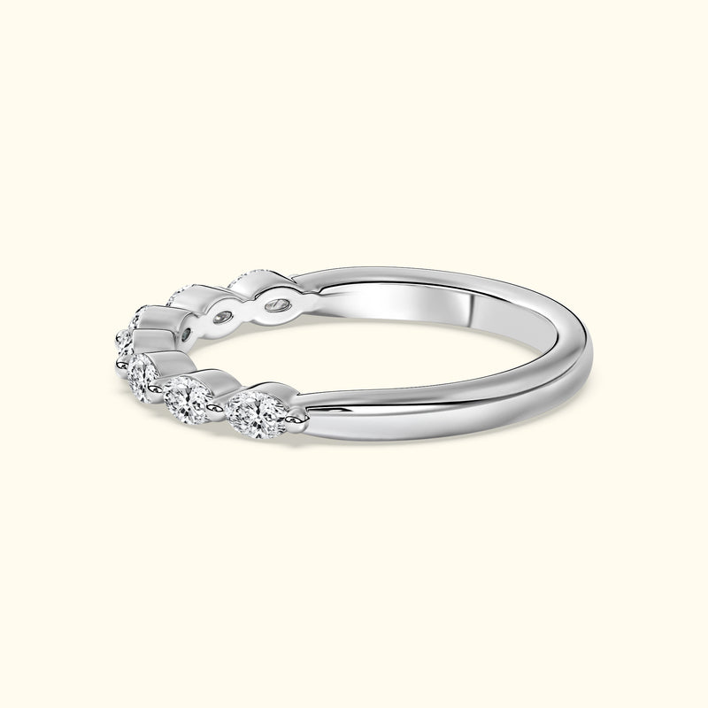 Delicate silver ring featuring five sparkling diamonds in a wavy design.