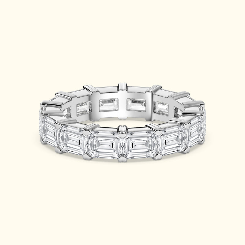 Elegant diamond band featuring alternating emerald-cut diamonds in a sleek setting.