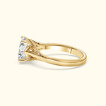 Gold engagement ring with a large, sparkling diamond and elegant prong setting.