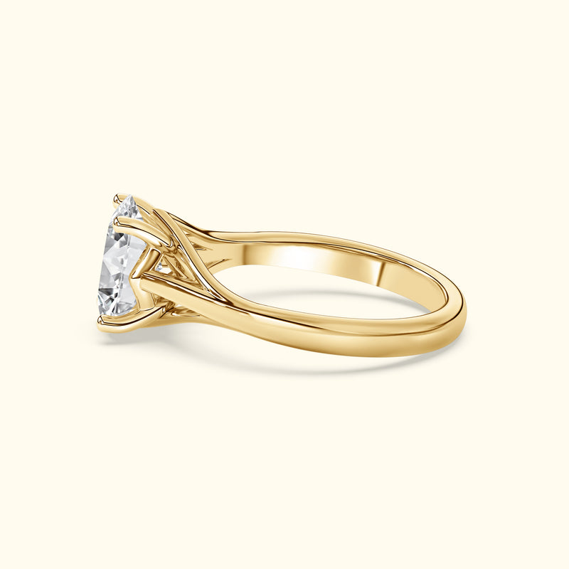 Gold engagement ring with a large, sparkling diamond and elegant prong setting.