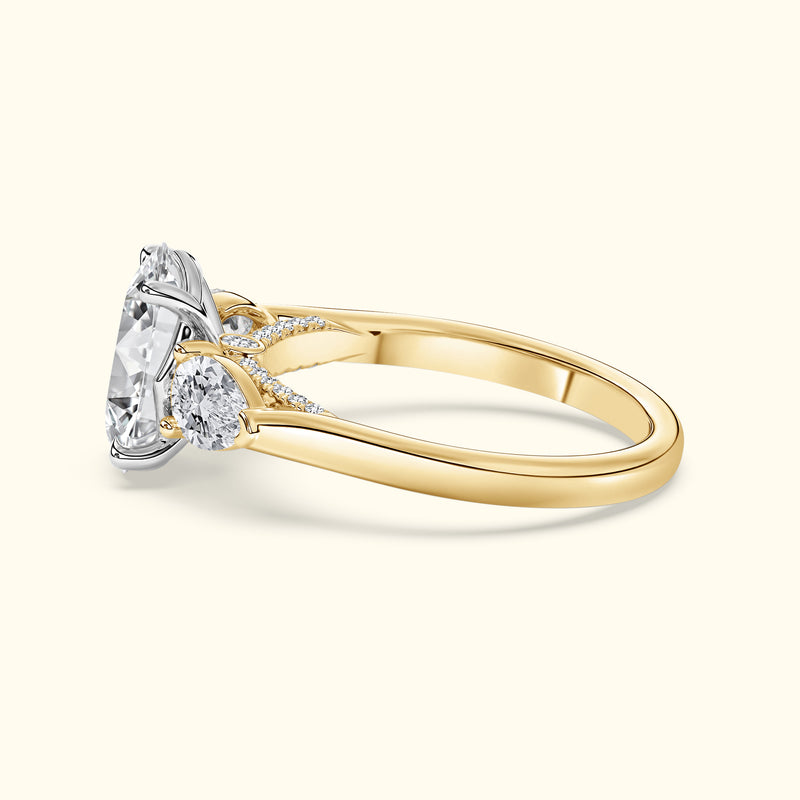 Elegant gold ring featuring a large center diamond and two smaller side stones.