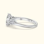 Elegant silver ring featuring a large central diamond and two smaller side diamonds.