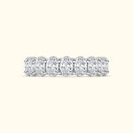 Elegant diamond band featuring multiple oval cut diamonds set in a sleek metal setting.