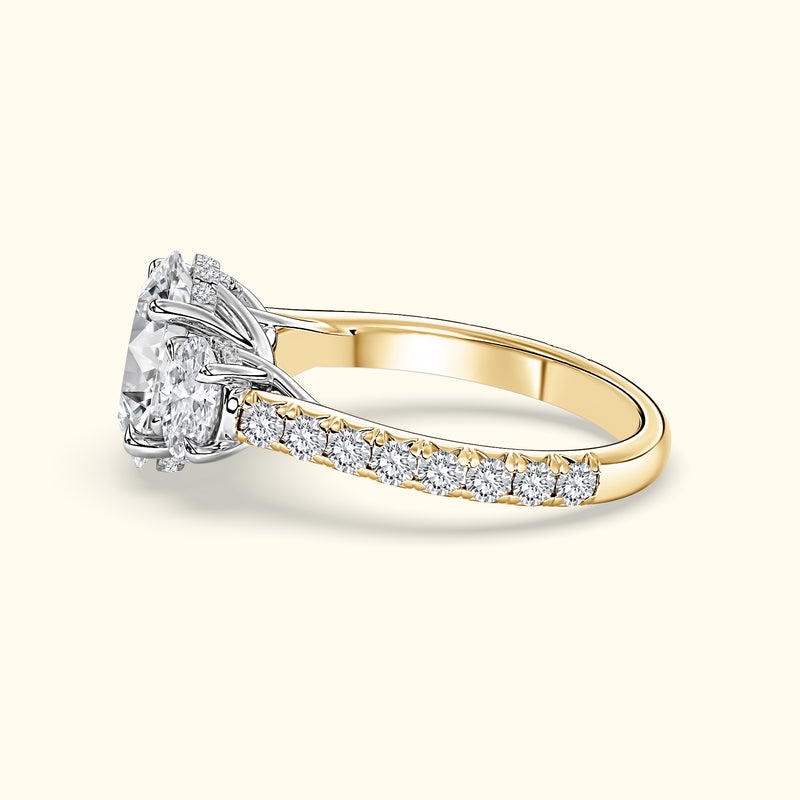 Sophisticated two-tone engagement ring featuring a large round diamond and smaller side stones.