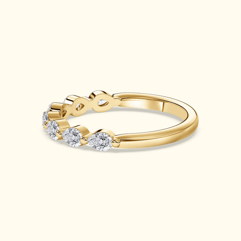 Delicate gold ring with five sparkling diamonds in a wave pattern.