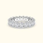 Elegant white gold band adorned with oval-shaped diamonds, featuring intricate detailing.