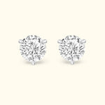 Brilliant diamond stud earrings with a four-prong setting on a light background.
