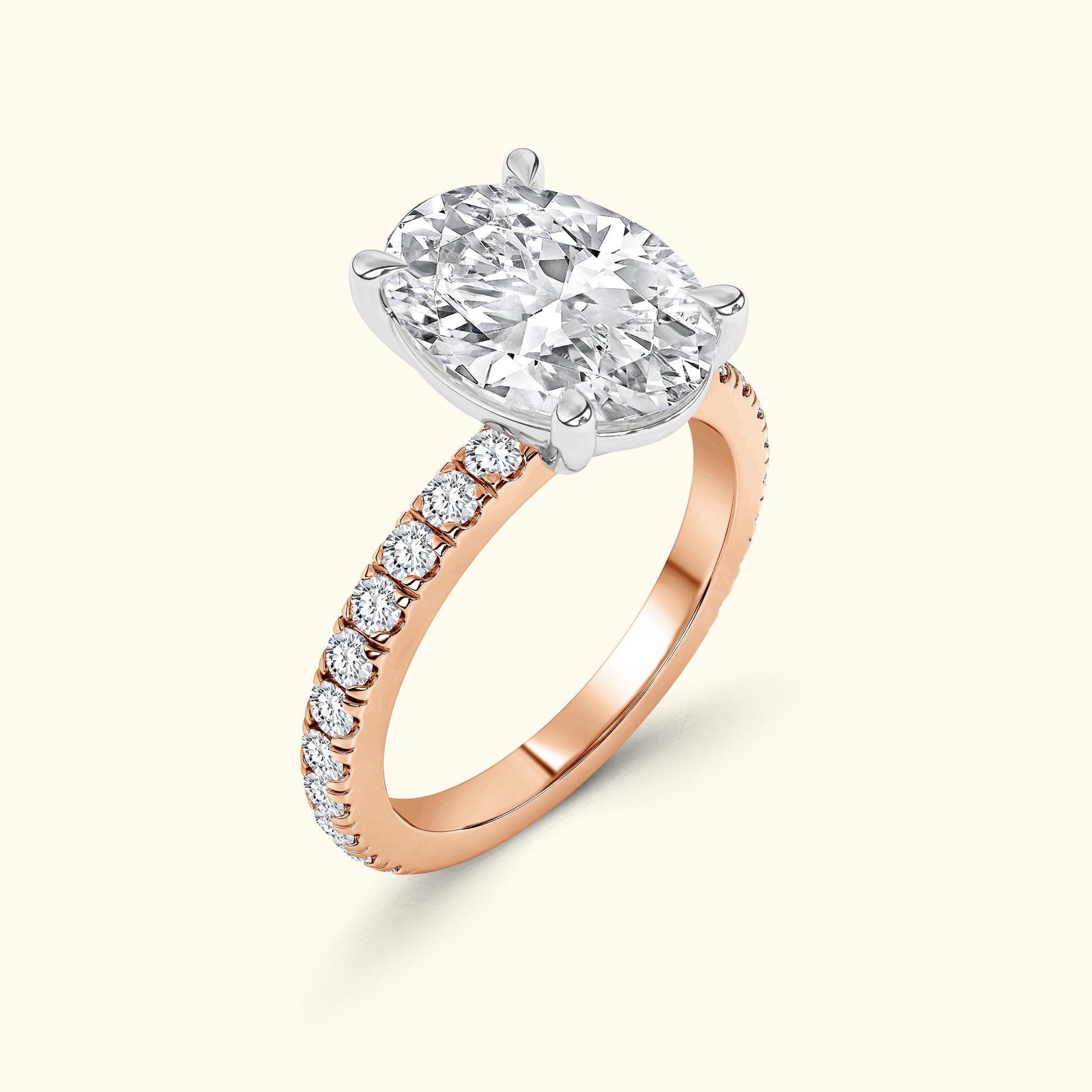 Rose gold ring featuring an oval diamond with a delicate row of smaller diamonds.