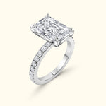 Elegant rectangular diamond ring with a band adorned in small stones.