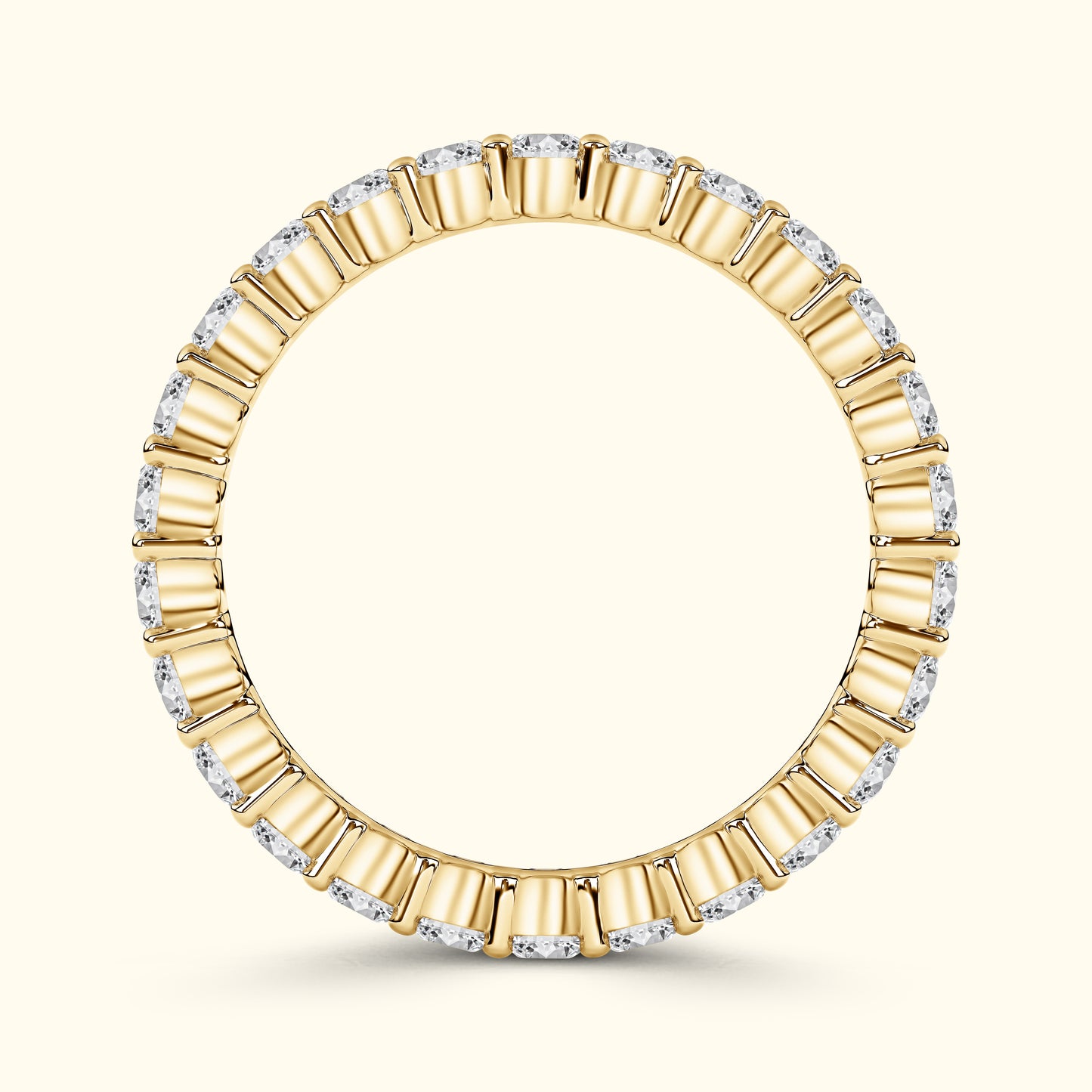 Gold ring with alternating rectangular and round diamonds, elegantly circular design.