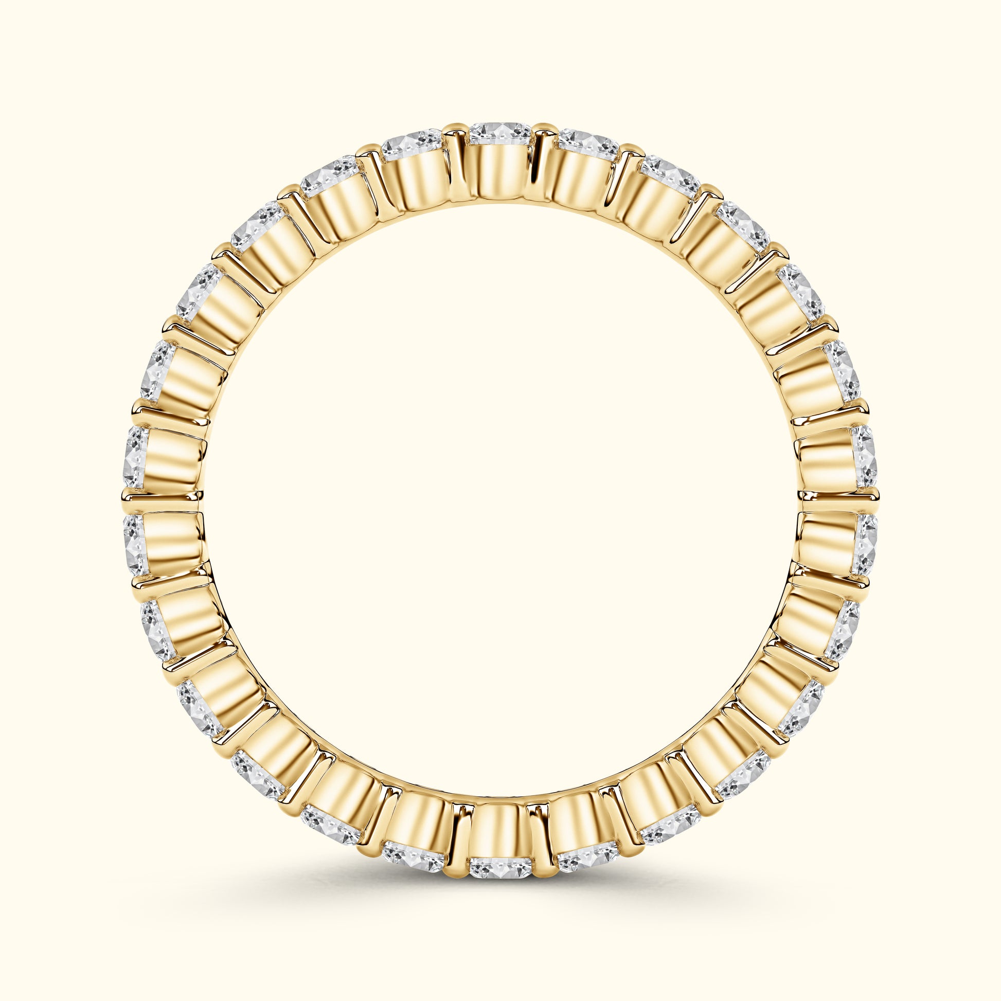 Gold ring with alternating rectangular and round diamonds, elegantly circular design.