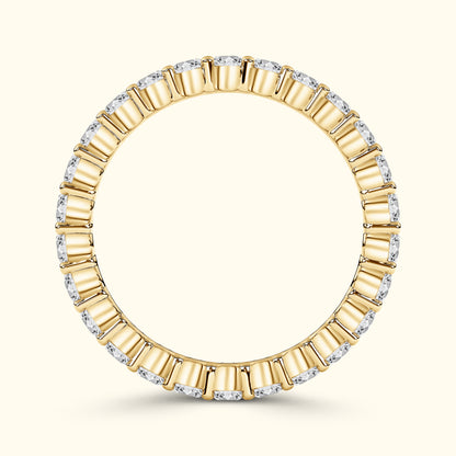 Gold ring with alternating rectangular and round diamonds, elegantly circular design.