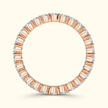 Rose gold band with alternating diamond and gold accents, elegantly circular.