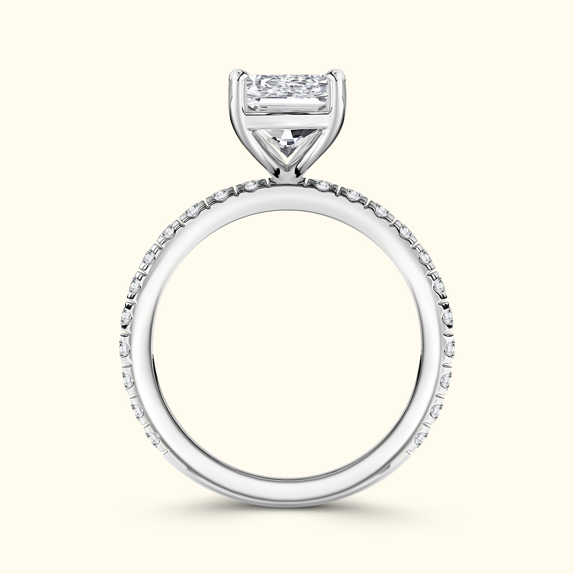 Elegant white gold engagement ring featuring a large diamond and smaller stones on the band.