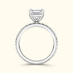 Elegant silver engagement ring featuring a central diamond surrounded by smaller stones.