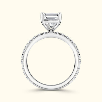 Elegant silver engagement ring featuring a central diamond surrounded by smaller stones.