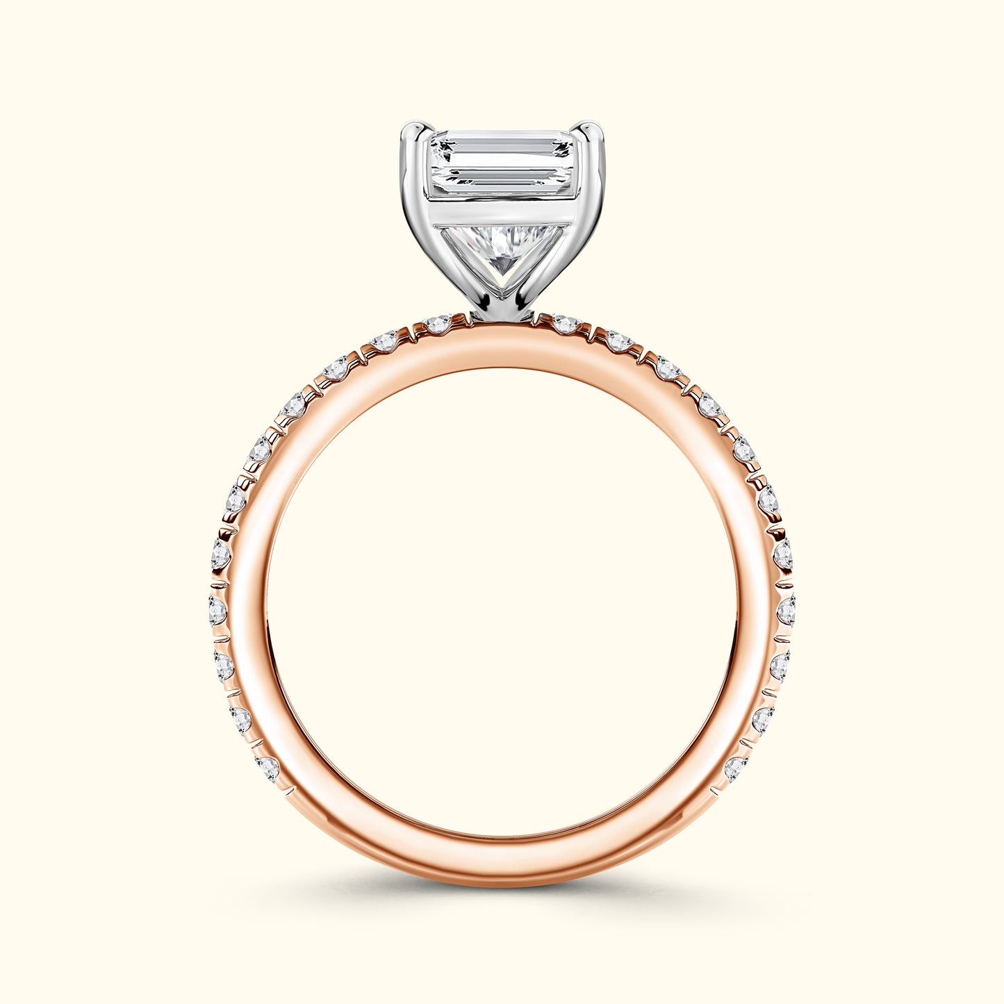 Rose gold engagement ring with a diamond band and a prominent three-stone setting.