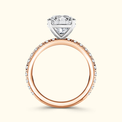 Heart-shaped diamond engagement ring with a rose gold band and small accent stones.