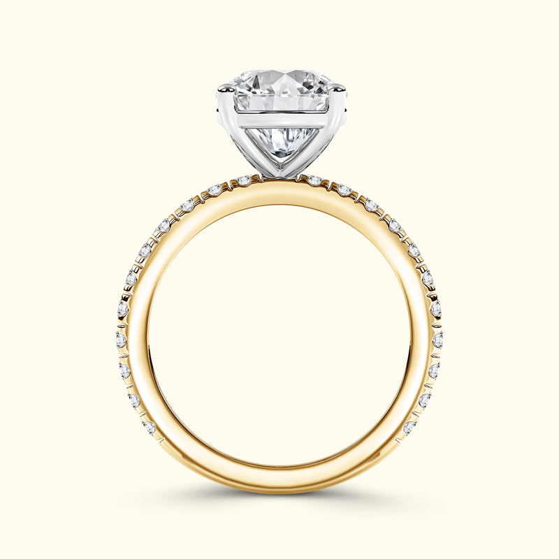 A two-tone engagement ring featuring a heart-shaped diamond setting on a gold band.
