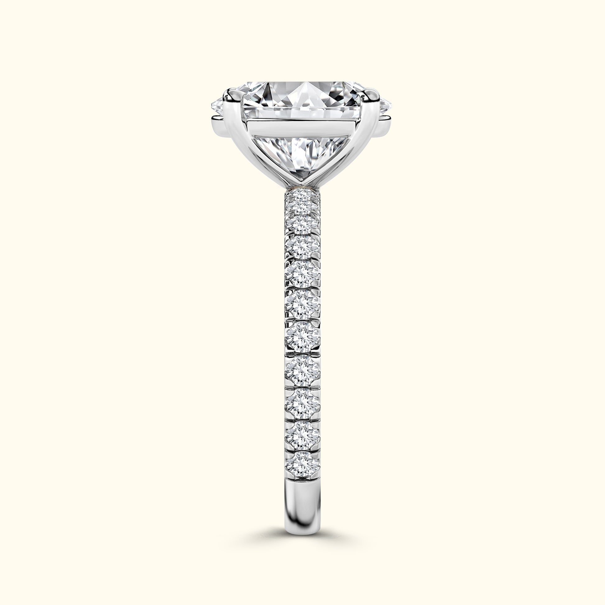 Elegant diamond engagement ring with a prominent center stone and a delicate band of smaller diamonds.