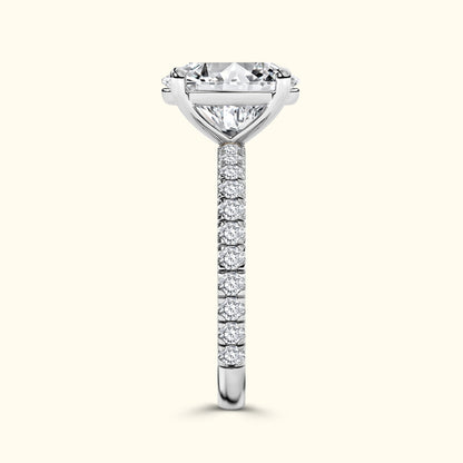 Elegant diamond engagement ring with a prominent center stone and a delicate band of smaller diamonds.