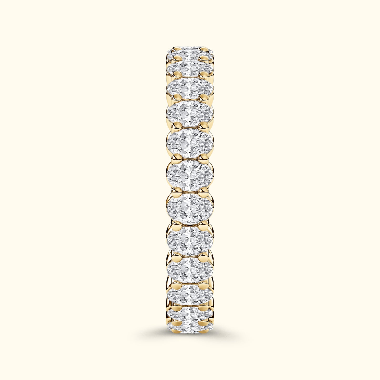 Gold band ring encrusted with sparkling, oval-shaped diamonds.