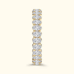 Gold band ring encrusted with sparkling, oval-shaped diamonds.