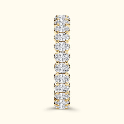 Gold band ring encrusted with sparkling, oval-shaped diamonds.