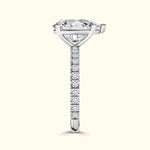 Solitaire engagement ring with a large diamond and a slender, jewel-encrusted band.