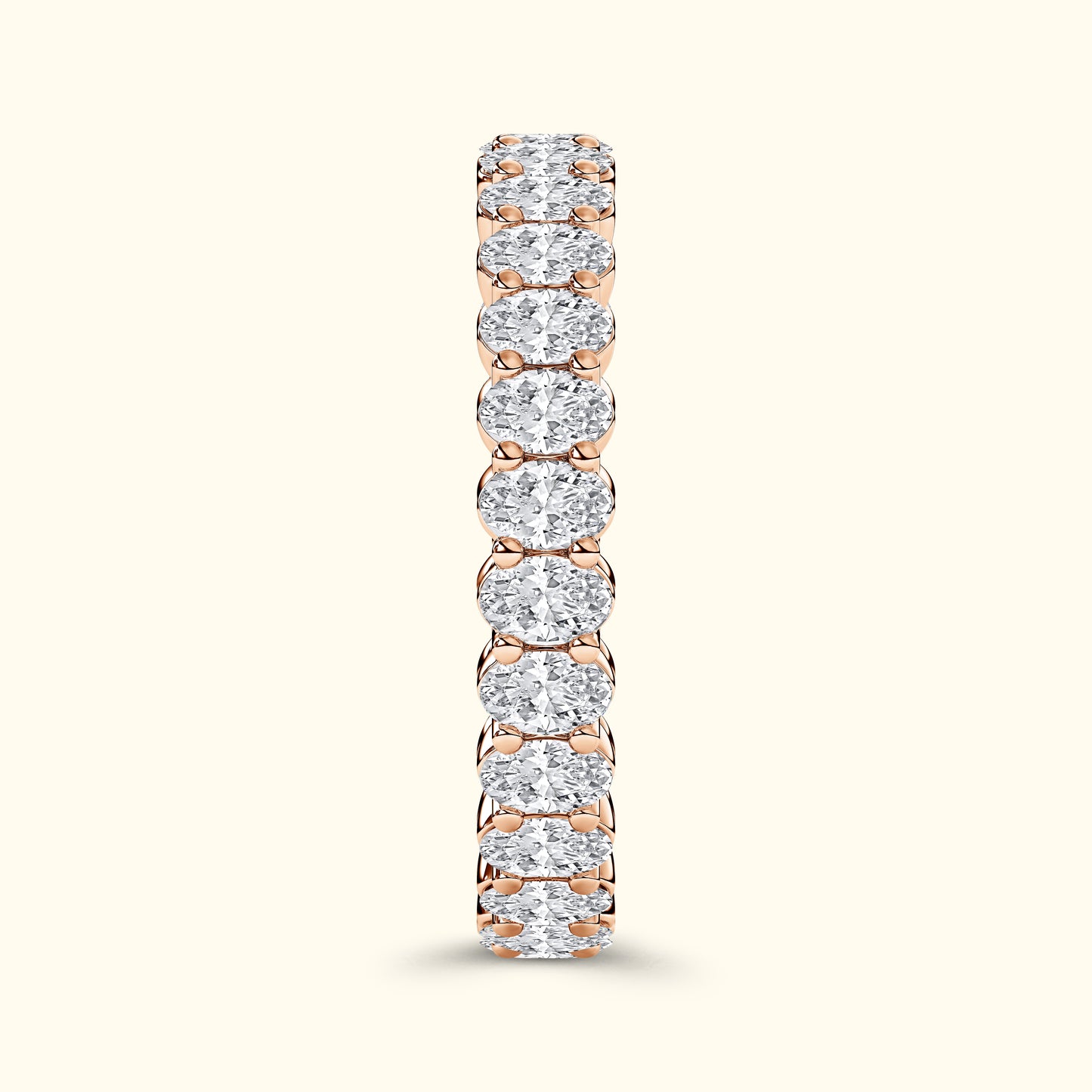 Rose gold ring featuring a row of sparkling round diamonds set in a prong setting.